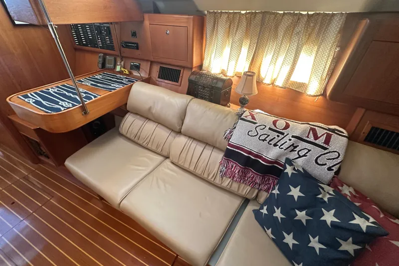 Slide: The Image of Interior of a 2002 Hunter 410 sailboat with cozy seating and nautical decor. - 23