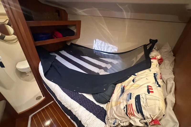 Slide: The Image of Cozy cabin interior of 2002 Hunter 410 sailboat with nautical-themed bedding. - 28