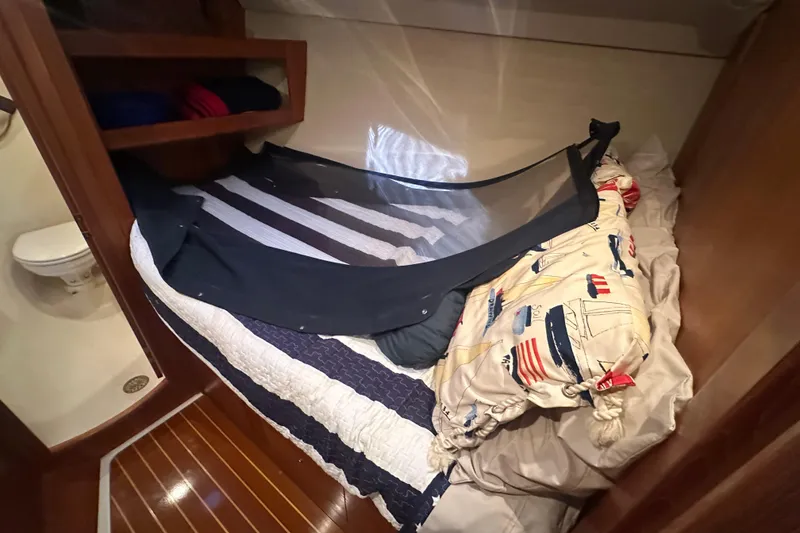 Slide: The Image of Cozy cabin interior of 2002 Hunter 410 sailboat with nautical-themed bedding. - 29