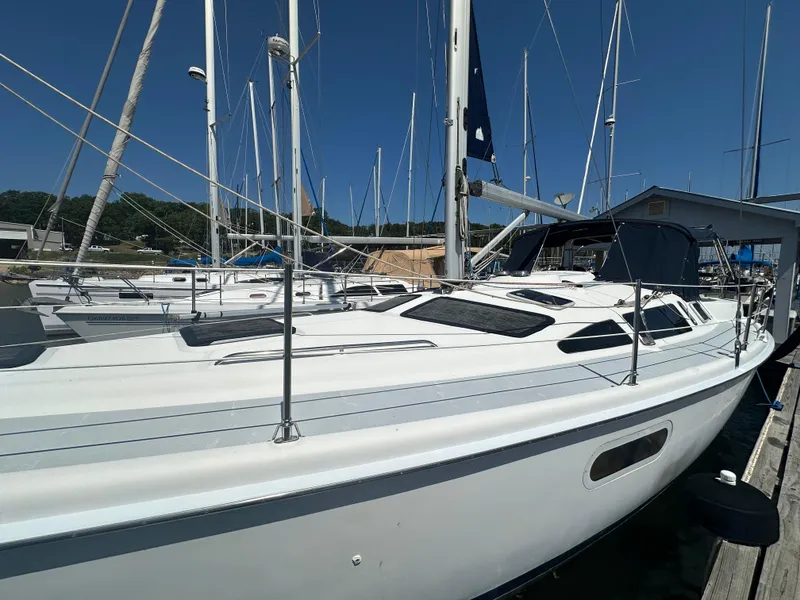 Slide: The Image of 2002 Hunter 410 sailboat docked at marina under clear blue sky. - 3