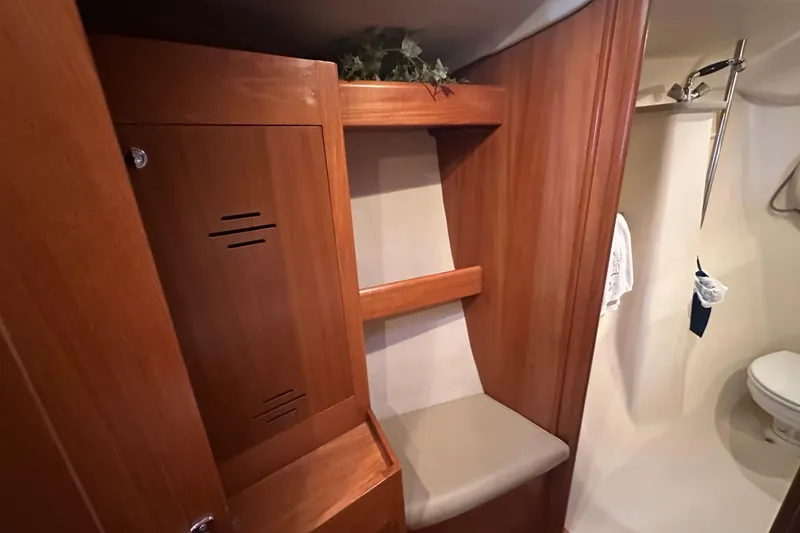 Slide: The Image of Interior of 2002 Hunter 410 sailboat with wooden cabinetry and compact bathroom. - 30