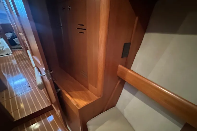 Slide: The Image of Interior of a 2002 Hunter 410 yacht, featuring wooden cabinetry and seating. - 35