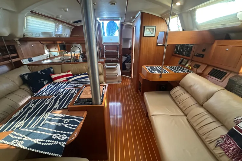 Slide: The Image of Luxurious interior of a 2002 Hunter 410 sailboat with elegant wood finishes and cozy seating. - 36