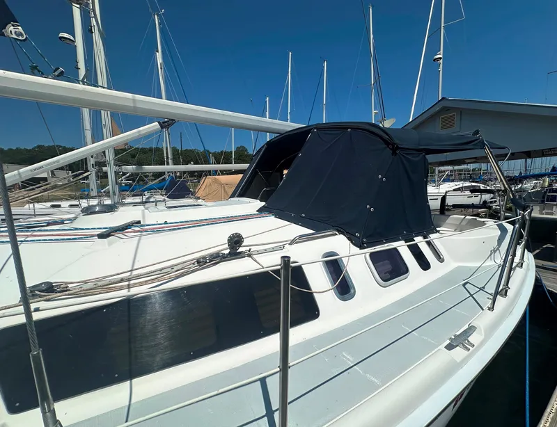 Slide: The Image of 2002 Hunter 410 sailboat docked at marina under clear blue sky. - 4