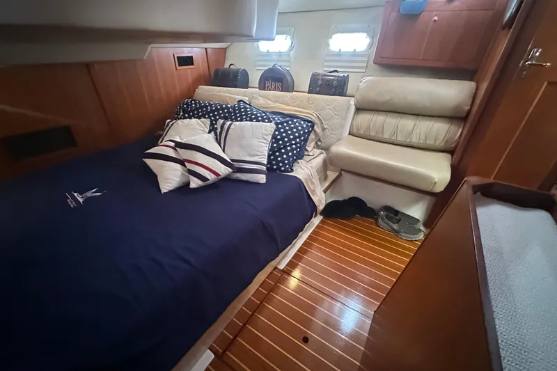 Slide: The Image of Luxurious cabin interior of 2002 Hunter 410 yacht with cozy bedding and wooden flooring. - 46