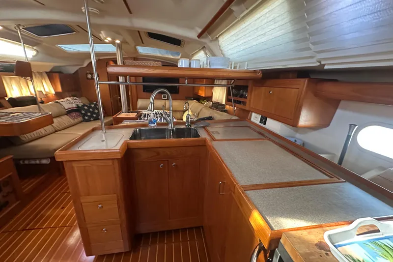 Slide: The Image of Interior of 2002 Hunter 410 yacht with wooden cabinetry and modern kitchen amenities. - 49