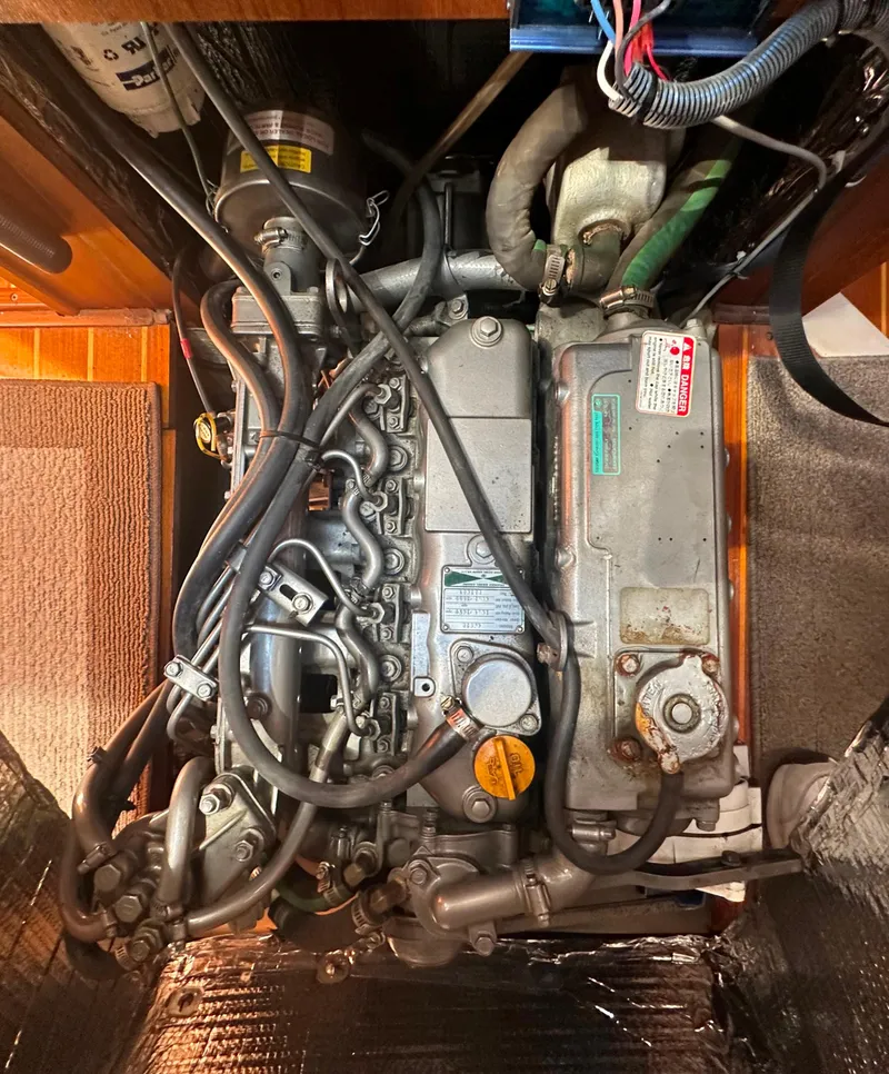 Slide: The Image of Engine compartment of a 2002 Hunter 410 sailboat, showcasing intricate mechanical components. - 50
