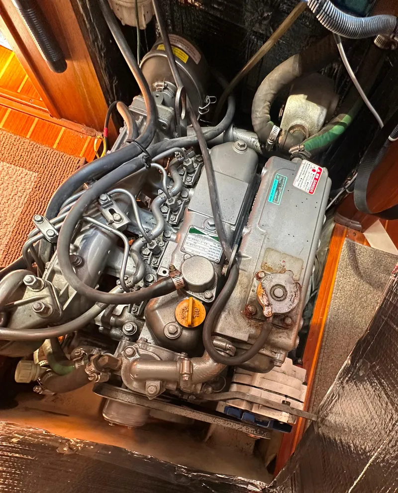 Slide: The Image of Engine of a 2002 Hunter 410 sailboat, showing detailed components and wiring. - 51