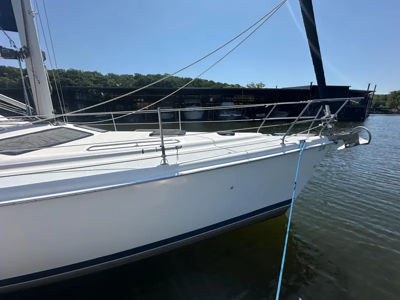 Slide: The Image of 2002 Hunter 410 sailboat docked on calm water under clear blue sky. - 6