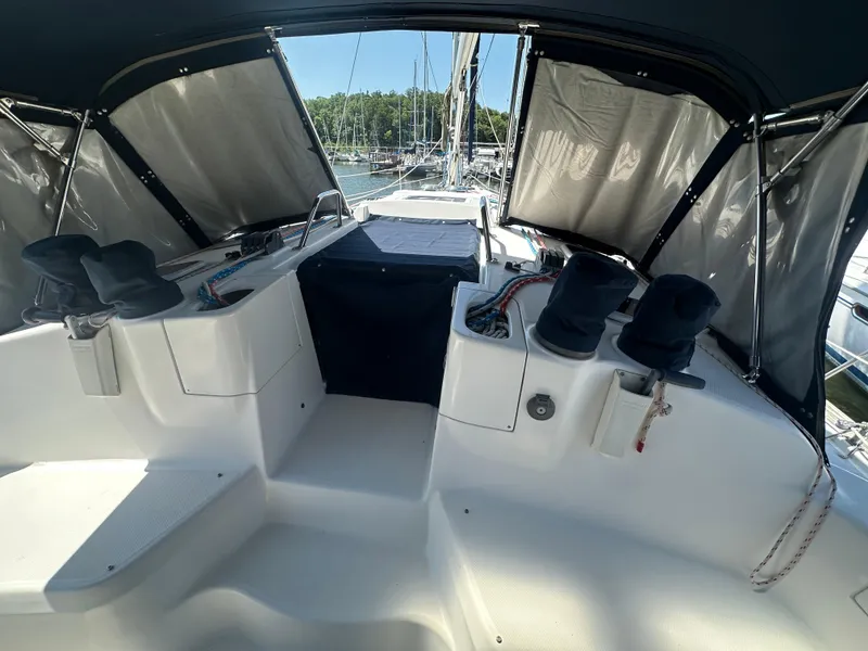 Slide: The Image of Cockpit of 2002 Hunter 410 sailboat with covered winches and marina view. - 7