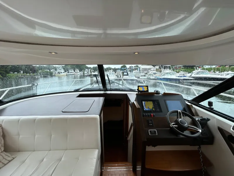 Slide: The Image of Interior view of 2015 Tiara Yachts C44 Coupe, featuring helm and seating area. - 10