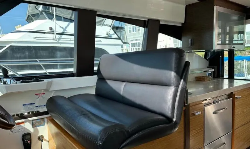 Slide: The Image of 2015 Tiara Yachts C44 Coupe interior with leather seating and modern kitchen amenities. - 14