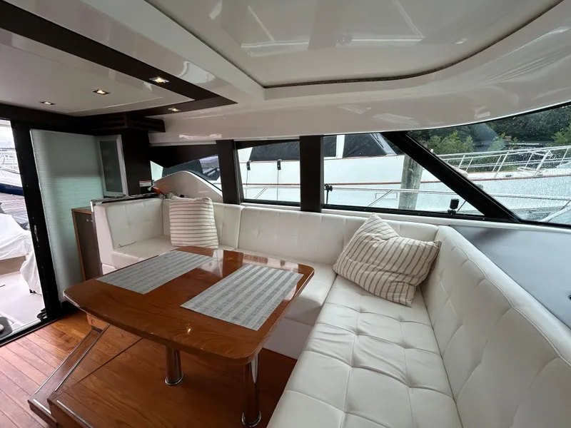 Slide: The Image of Luxurious interior of 2015 Tiara Yachts C44 Coupe with white seating and wooden table. - 15