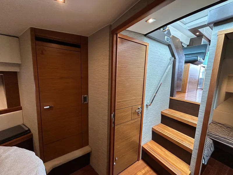 Slide: The Image of Interior of 2015 Tiara Yachts C44 Coupe, featuring wooden doors and stairs. - 17