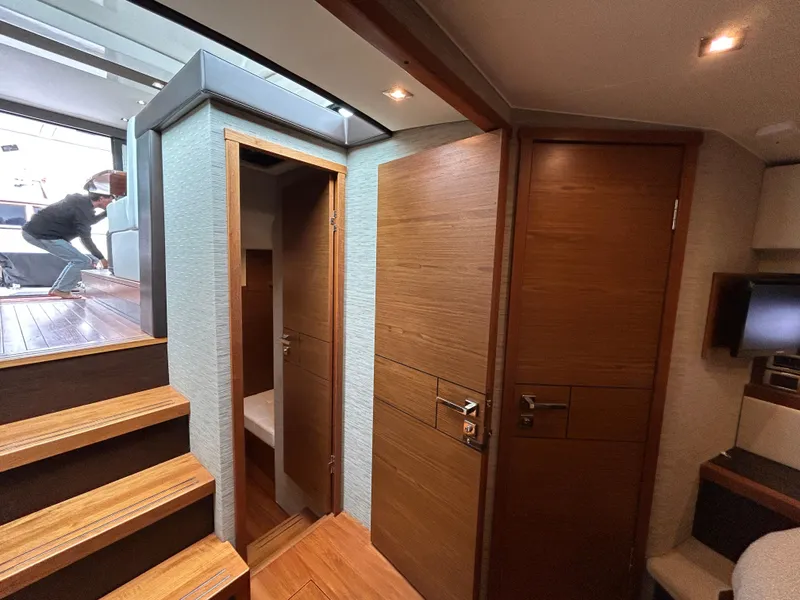 Slide: The Image of Interior of 2015 Tiara Yachts C44 Coupe, featuring wooden doors and stairs. - 18