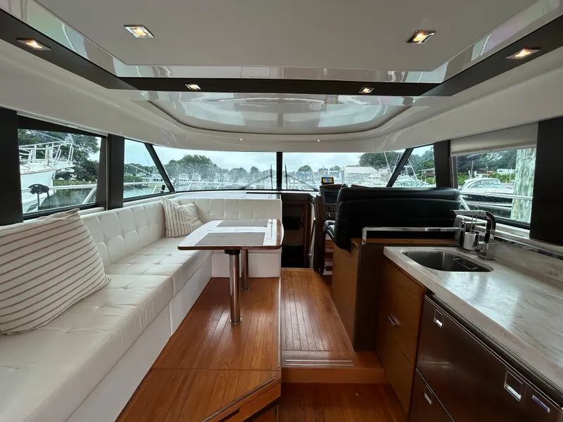 Slide: The Image of Luxurious interior of 2015 Tiara Yachts C44 Coupe with seating and kitchenette. - 6