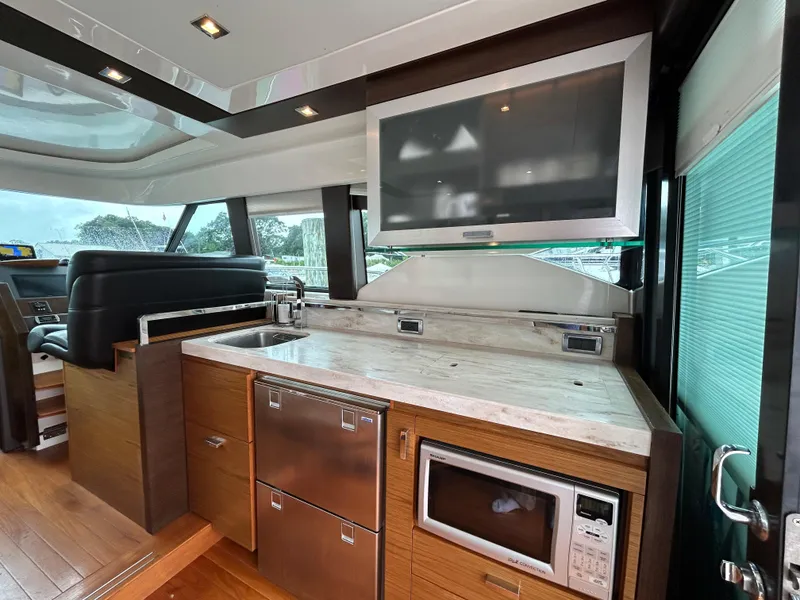 Slide: The Image of Interior of 2015 Tiara Yachts C44 Coupe with modern kitchen amenities. - 7