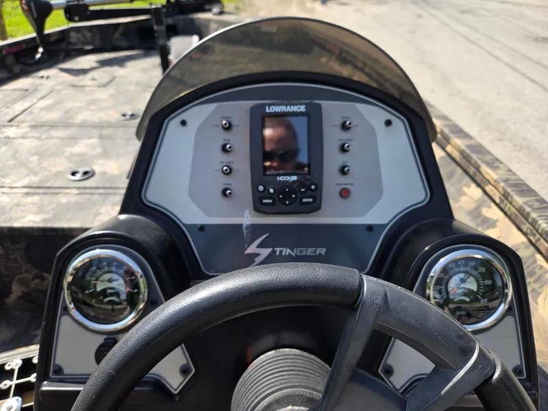 Slide: The Image of Dashboard of a 2018 Lowe 175 Stinger boat with steering wheel and gauges. - 10