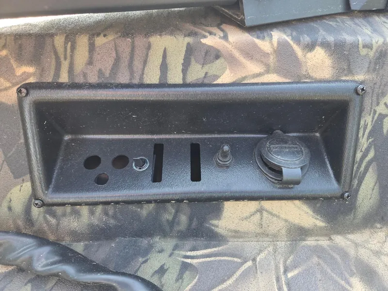 Slide: The Image of Control panel on a 2018 Lowe 175 Stinger boat with camouflage design. - 16