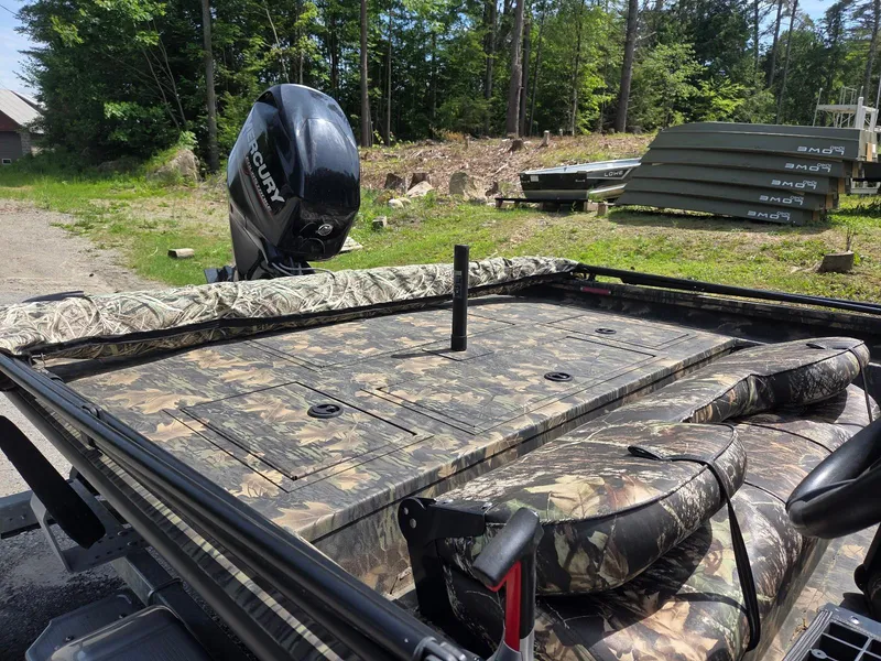 Slide: The Image of 2018 Lowe 175 Stinger boat with camouflage design and Mercury outboard motor. - 4