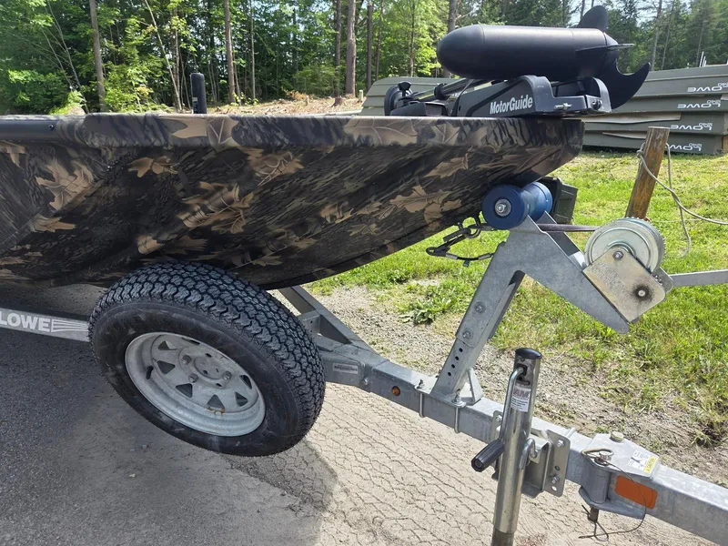 Slide: The Image of 2018 Lowe 175 Stinger boat on trailer with camouflage design and MotorGuide motor. - 7
