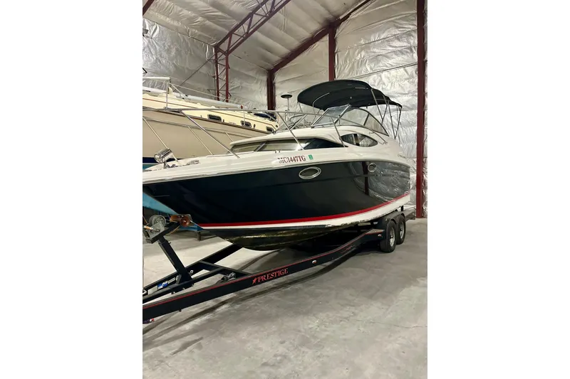 The Image of 2006 Regal 2565 Window Express boat on trailer in storage facility. - 0