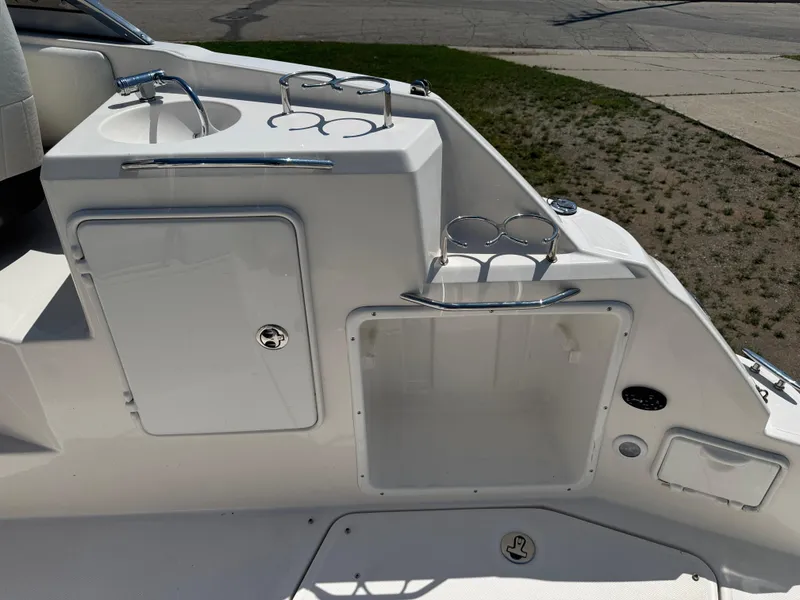 Slide: The Image of 2006 Regal 2565 Window Express boat interior with sink and storage compartments. - 10