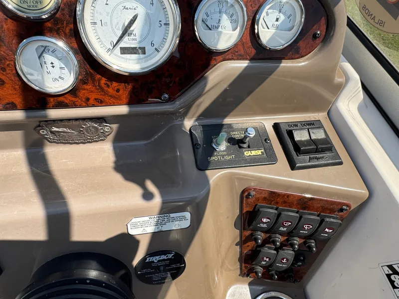 Slide: The Image of Control panel of a 2006 Regal 2565 Window Express boat with gauges and switches. - 16