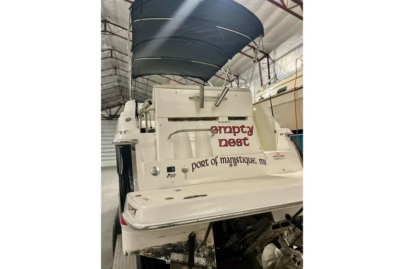 Slide: The Image of 2006 Regal 2565 Window Express boat named "Empty Nest" in storage, Manistique, MI. - 2