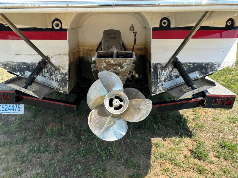 Slide: The Image of Rear view of a 2006 Regal 2565 Window Express boat with visible propeller and trim tabs. - 4