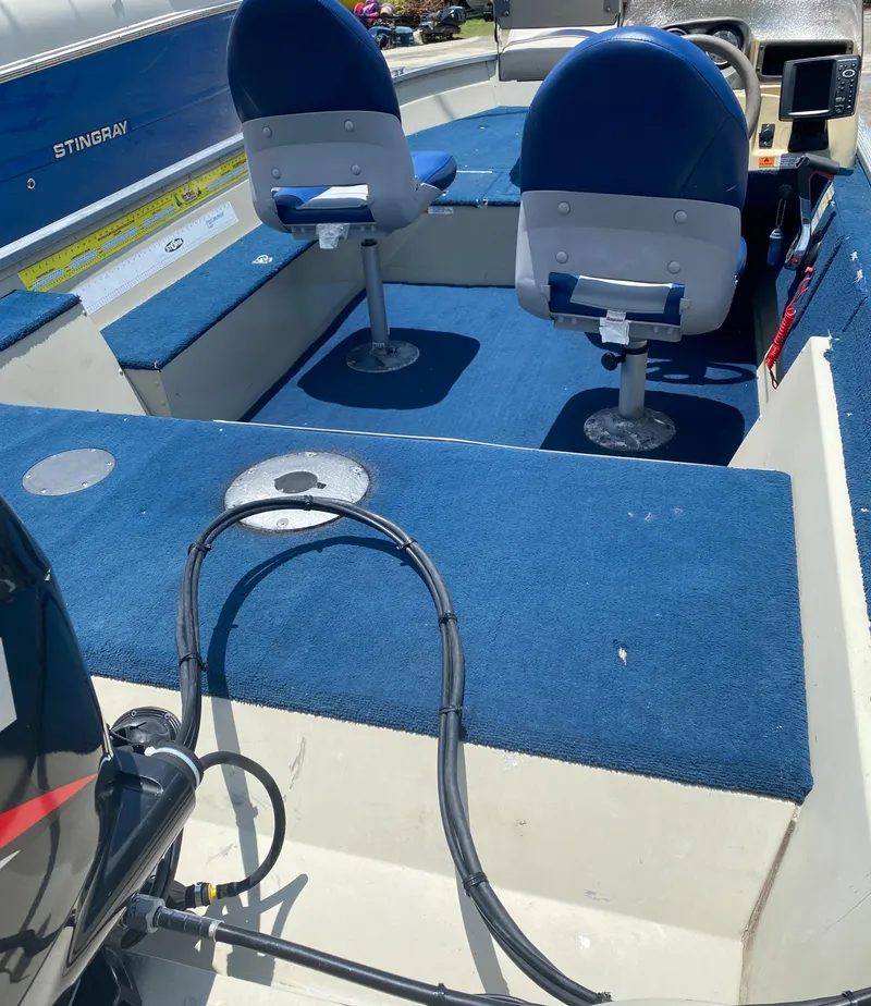 Slide: The Image of 2001 Lowe FM165S boat interior with blue carpet and seating. - 3