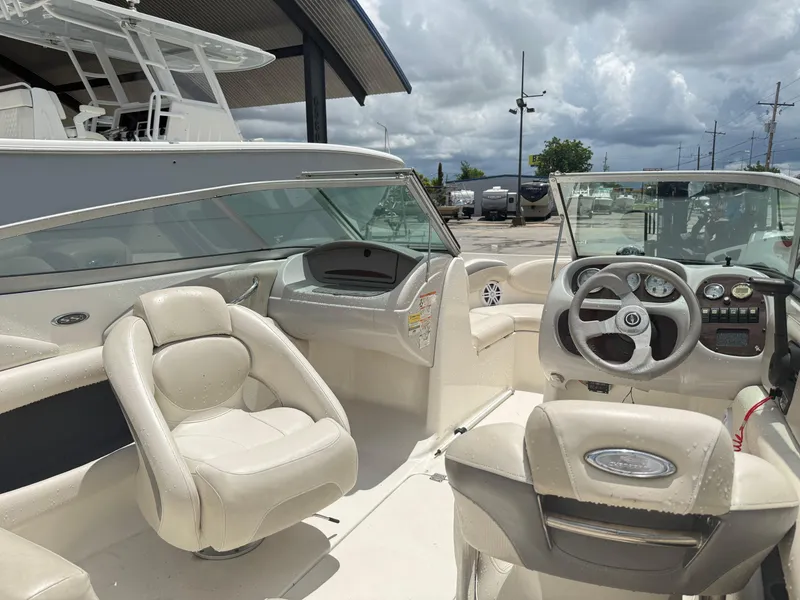 Slide: The Image of 2007 Chaparral 190 SSi boat interior with steering wheel and seating under cloudy sky. - 11