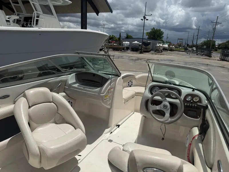 Slide: The Image of 2007 Chaparral 190 SSi boat interior with steering wheel and seating under cloudy sky. - 8