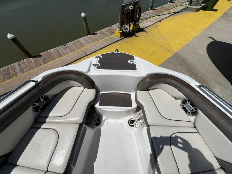 Slide: The Image of Interior view of 2012 Yamaha Boats 242 Limited, featuring cushioned seating and cup holders. - 8