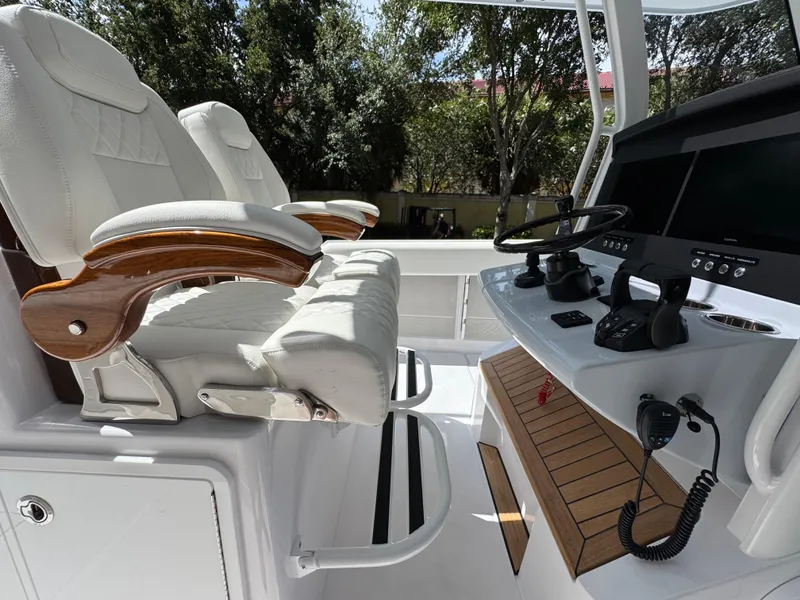Slide: The Image of Luxury helm of 2025 Jupiter 380LS boat with plush seating and advanced controls. - 14