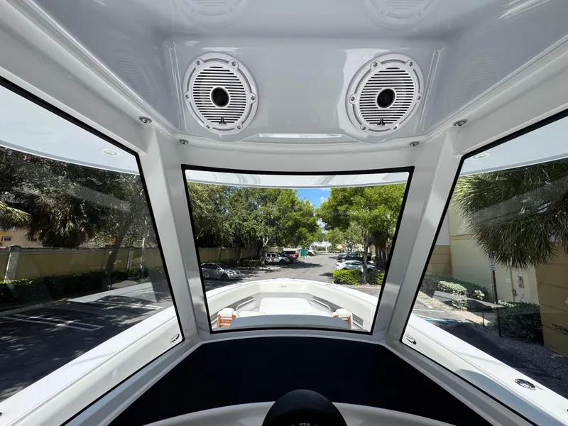 Slide: The Image of Interior view of 2025 Jupiter 380LS boat with large windows and ceiling speakers. - 19