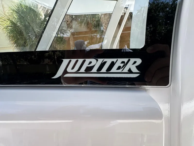 Slide: The Image of Jupiter 380LS 2025 logo on a boat window with reflection. - 26