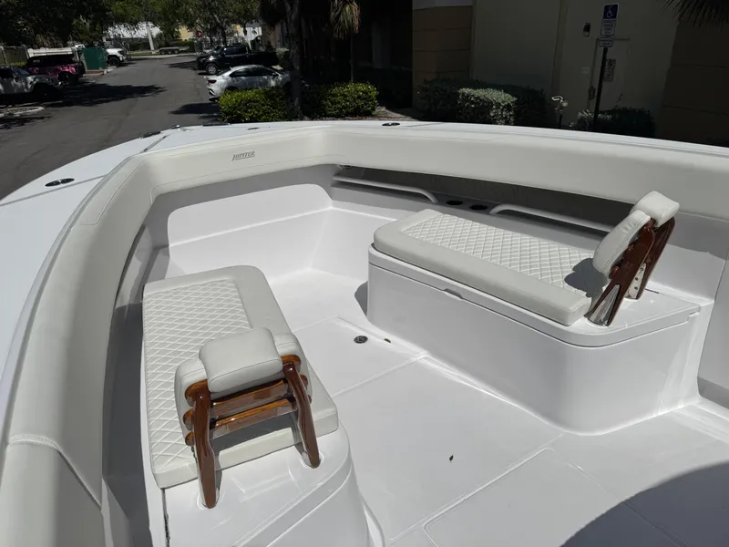 Slide: The Image of 2025 Jupiter 380LS boat interior with white cushioned seating and wooden accents. - 4