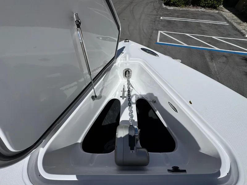 Slide: The Image of Open anchor compartment on 2025 Jupiter 380LS boat, showcasing chain and mechanism. - 7