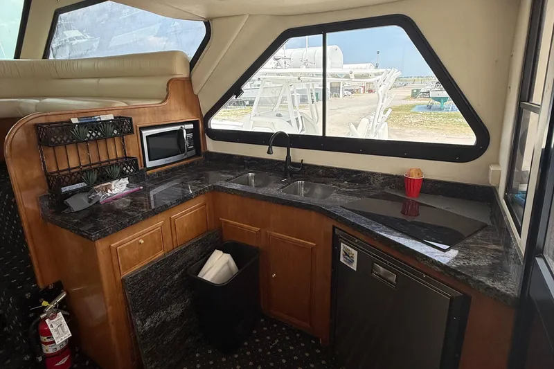 Slide: The Image of Luxurious kitchen interior of 2001 Custom Sports Catamaran 44 with granite countertops and modern appliances. - 10