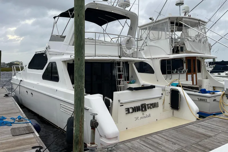 Slide: The Image of Custom Sports Catamaran 44, 2001 model, docked at marina on a cloudy day. - 3
