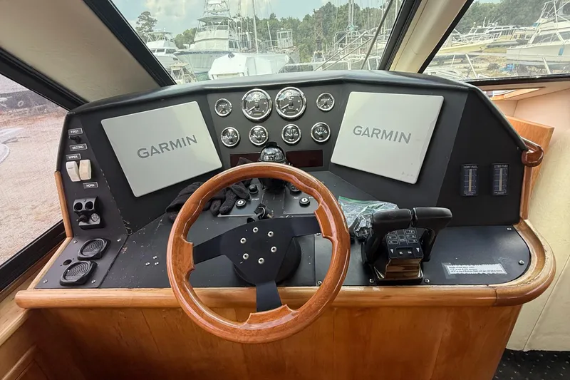 Slide: The Image of Helm of 2001 Custom Sports Catamaran 44 with Garmin navigation displays and wooden steering wheel. - 5