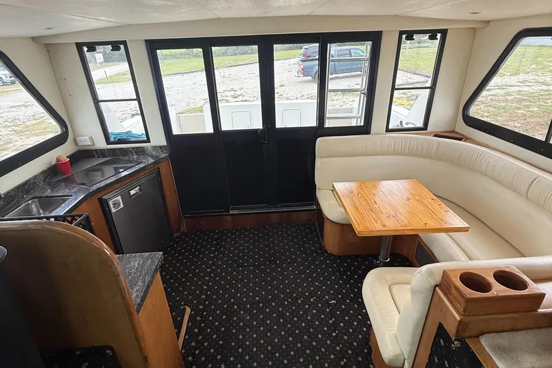 Slide: The Image of Interior of 2001 Custom Sports Catamaran 44 with kitchen and seating area. - 6