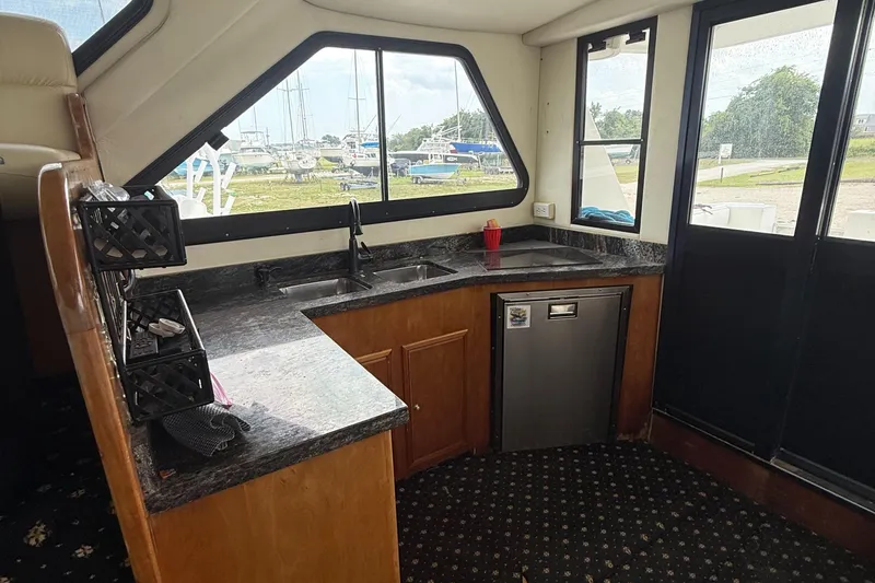 Slide: The Image of Interior of 2001 Custom Sports Catamaran 44 with kitchenette, sink, and window view. - 7