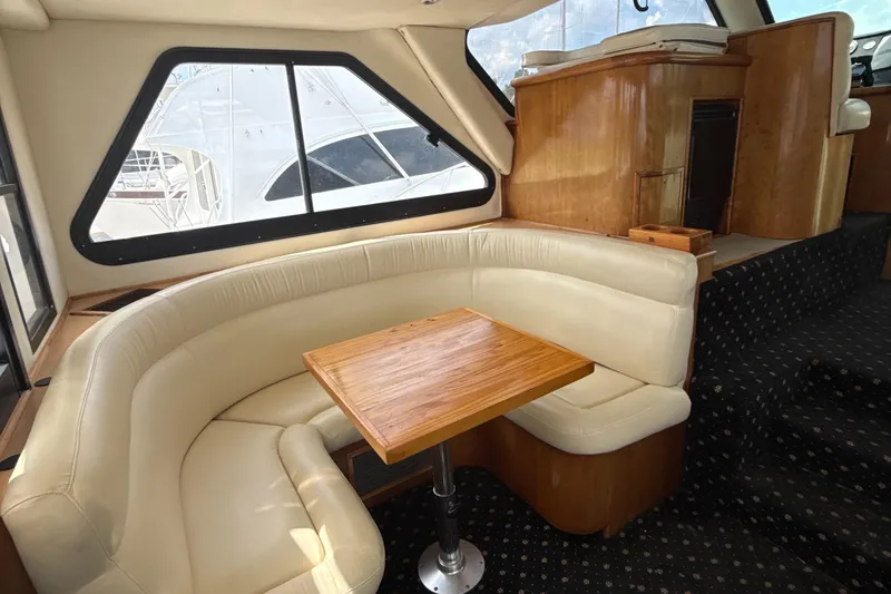 Slide: The Image of Luxurious interior of 2001 Custom Sports Catamaran 44 with plush seating and wooden table. - 8