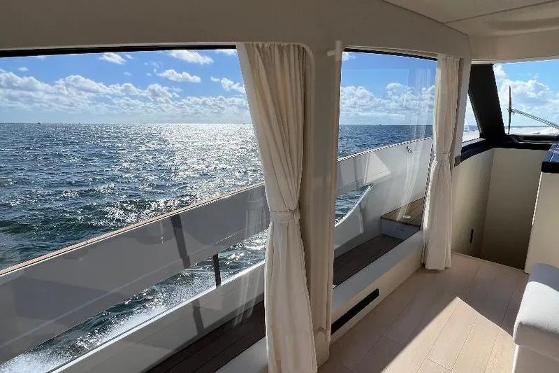 Slide: The Image of Interior view of 2025 Azimut SeaDeck6 yacht with ocean scenery through large windows. - 10