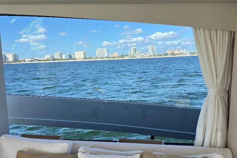 Slide: The Image of View from 2025 Azimut SeaDeck6 yacht window, overlooking ocean and city skyline. - 15