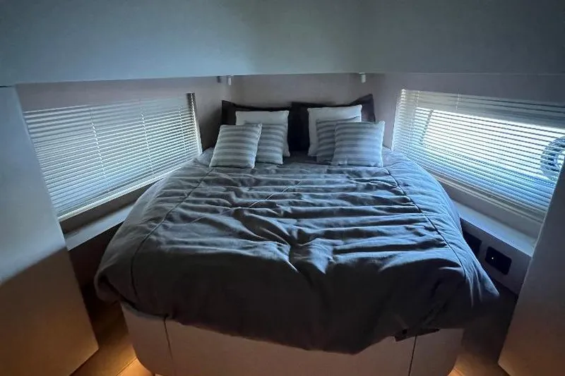 Slide: The Image of Luxurious bedroom interior of 2025 Azimut SeaDeck6 yacht with cozy bedding and modern design. - 16