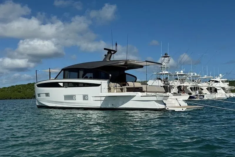 Slide: The Image of 2025 Azimut SeaDeck6 yacht on calm water, clear sky background. - 2