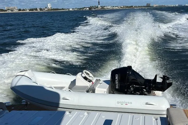 Slide: The Image of Azimut SeaDeck6 2025 cruising with inflatable boat and Suzuki engine on open water. - 5